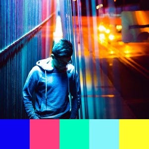 A color palette created from an image of a person at night with reflections of blue, pink, and yellow streetlights