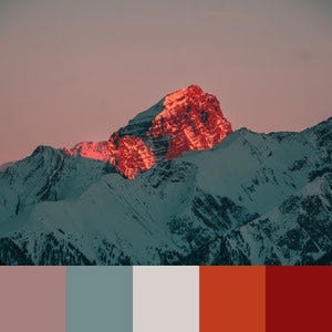 A color palette created from an image of the sun rising over snowy mountains