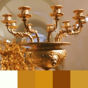 A color palette created from an image of a golden candelabra with a beige and gold background