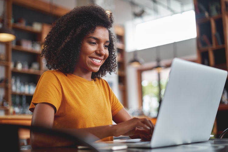 A higher education student uses a computer to log in to a document management system and add her online signature to a financial document.