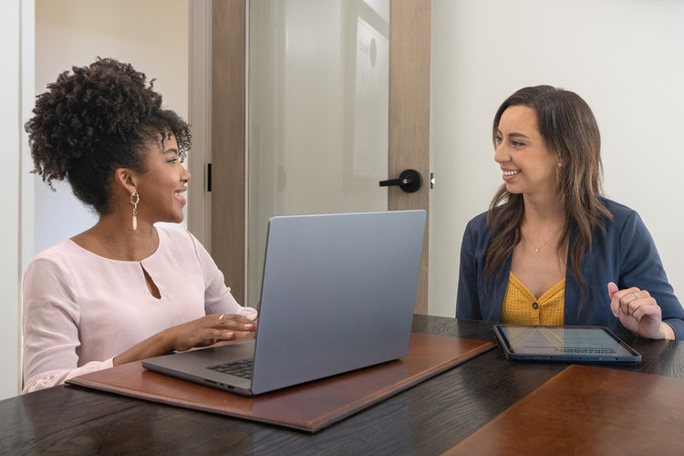 Two people in an office working on a laptop going over their 30-day notice letter to landlord or tenant.