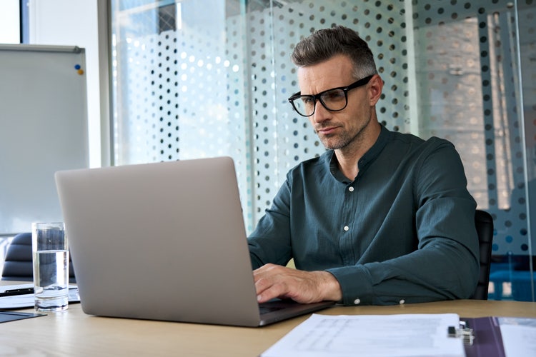 A man in an office reads over a data processing agreement.