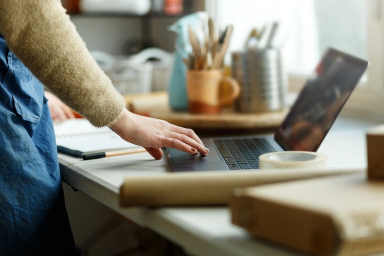 A person registering their company name on a laptop.