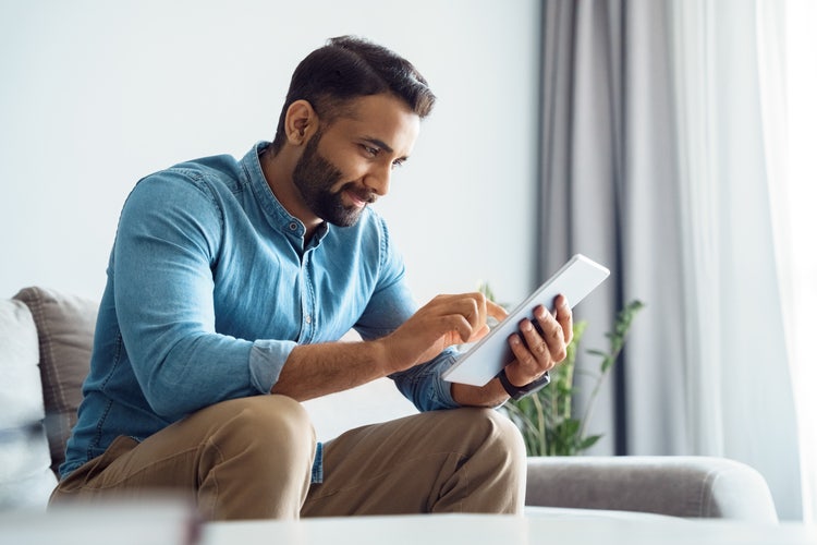 A man looks at an options contract on his tablet.