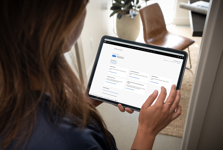 A businesswoman uses a tablet to schedule one-on-one training sessions to learn how to use Adobe Acrobat.