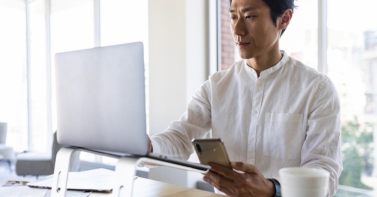 A businessperson reviewing a copy of a contract at their office desk