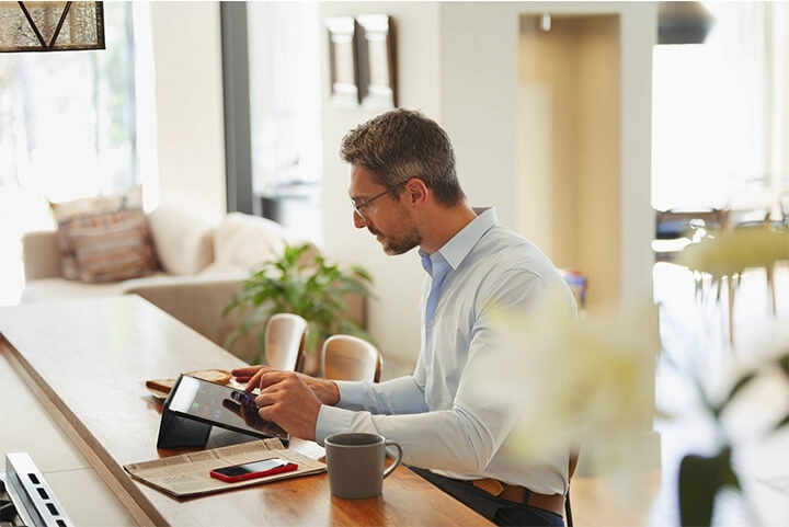 A business owner creating an invoice on their tablet device at a table