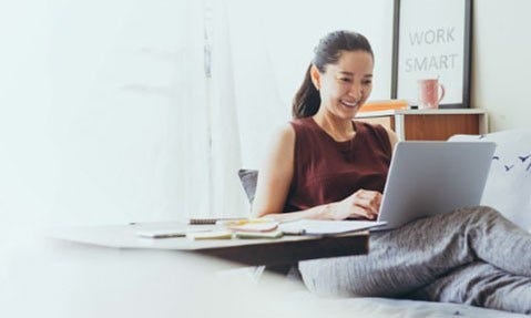 Woman sitting down looking at her laptop