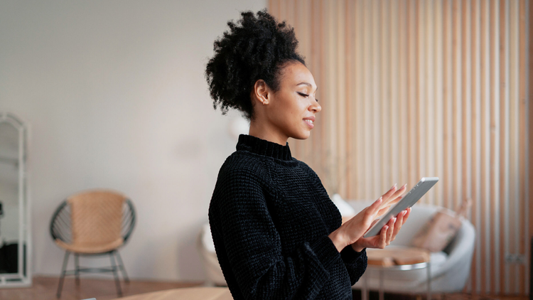 Woman holding a tablet device.