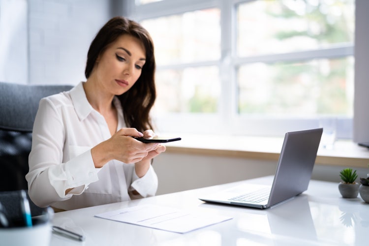 A woman uses OCR technology on her phone to scan a document