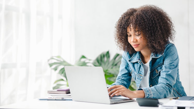 A young woman uses her laptop to extract text from images.