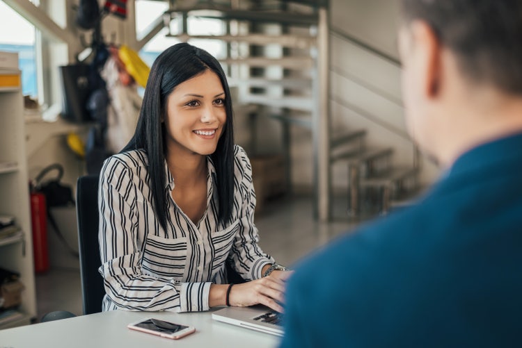 A woman is using her car bill of sale to obtain a car title.