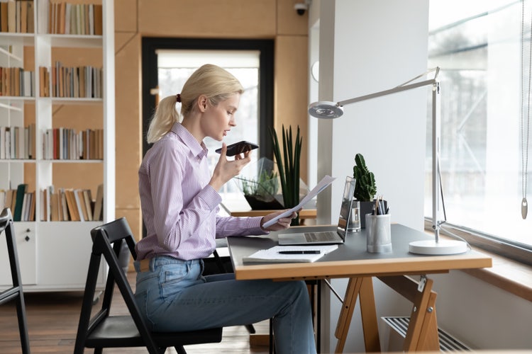 A woman in an office performs the duties of a virtual assistant.