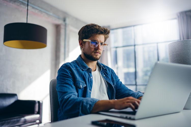 A man translates text with OCR on his laptop.