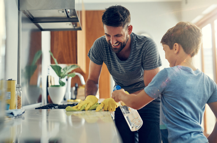 A father and son use a spring cleaning checklist to clean their home.
