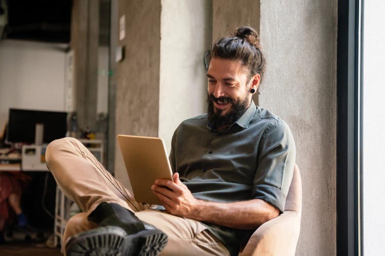 A man uses an iPad to write a bill of sale for an ATV.