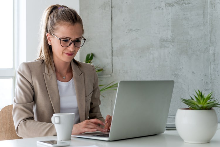 Woman learns about document version control on her laptop.