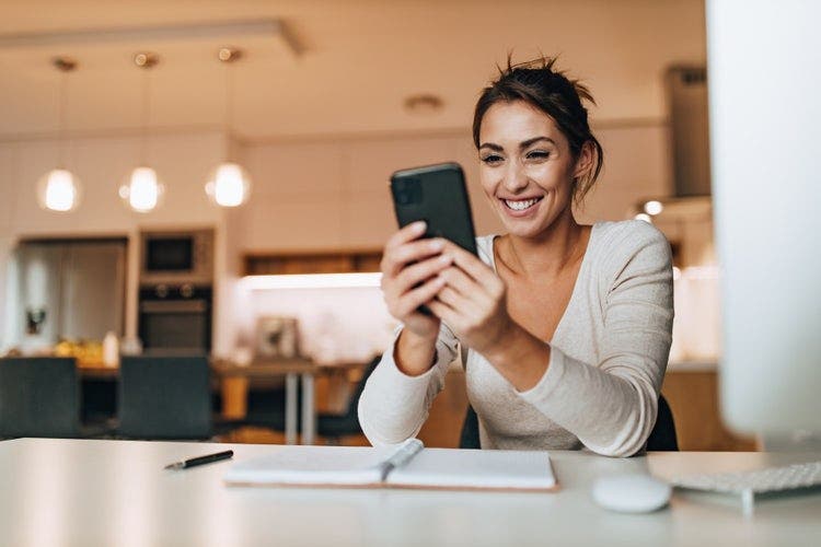 A woman edits a PDF from home using an iPhone.