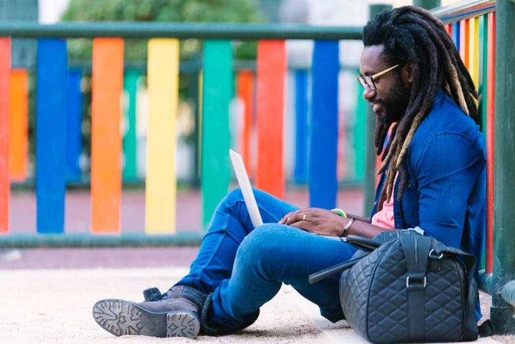 A man uses a laptop to convert email to PDF.