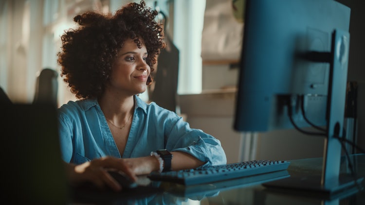 A woman collaborates on a PDF document using a desktop computer.