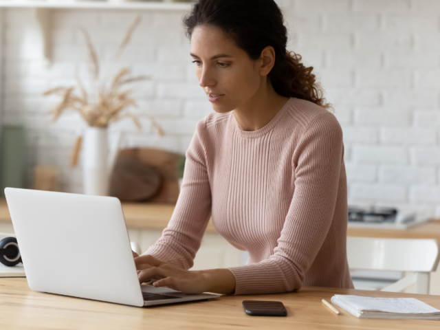 A person working on a laptop to make a PDF editable.