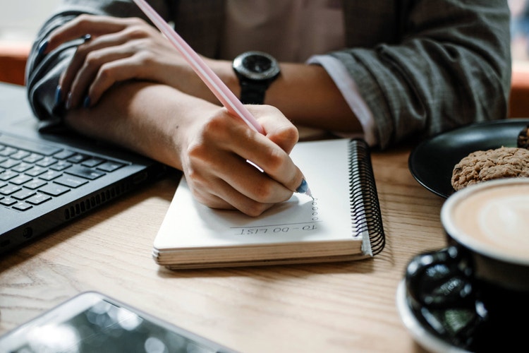 To do list, organize plans, projects, checklist, Productivity Works. Woman writing to do list. Close up of female hand writing check note in notebook