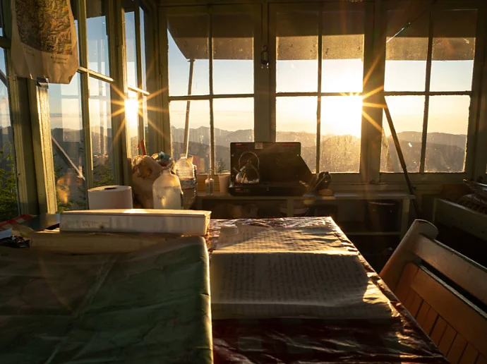 The sun illuminating a room with many windows