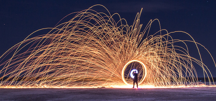 Person doing light painting photography at the beach