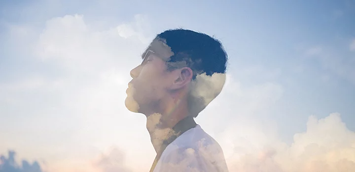 A person's face with clouds surrounding them