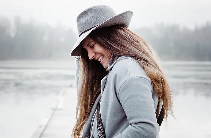 Person looking down at ground while posing for photo as an example of lifestyle photography