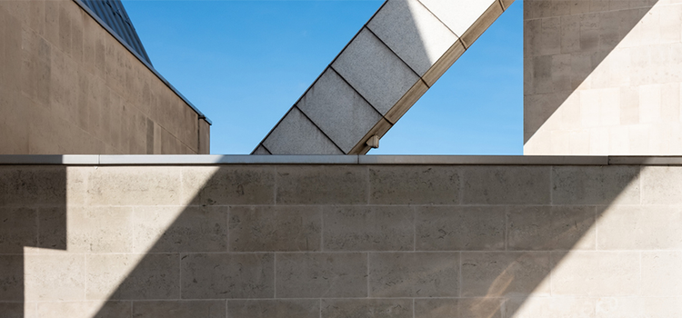 A photo of an AC duct on the roof of a building creating geometric shapes