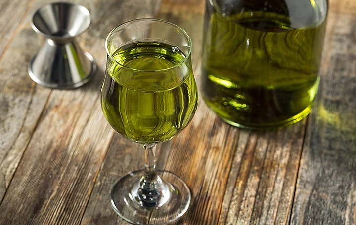 A chartreuse-coloured liquid in a glass