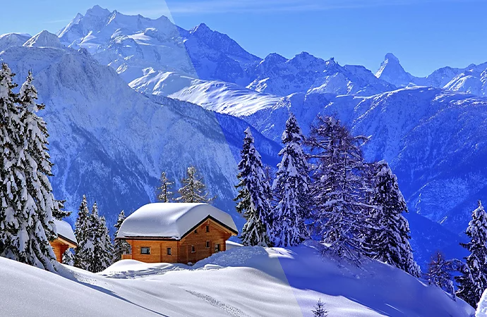 A wood cabin covered in snow on a mountain