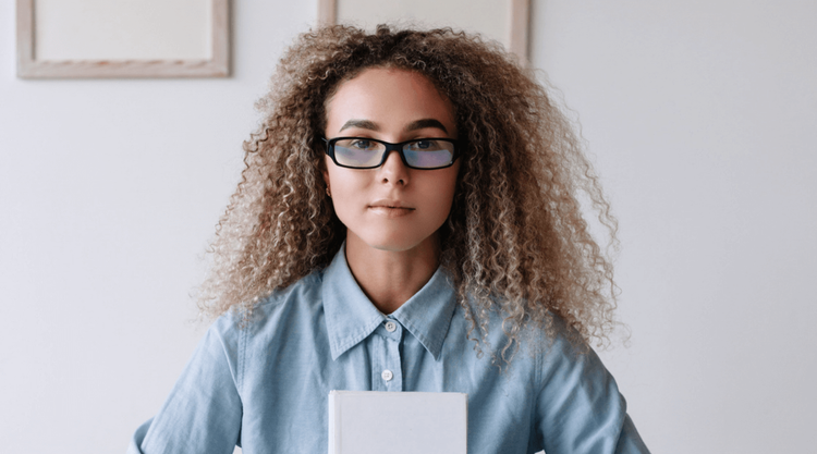 Person wearing glasses staring into the camera