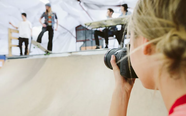 A photo of a photographer taking photos of skateboarders.