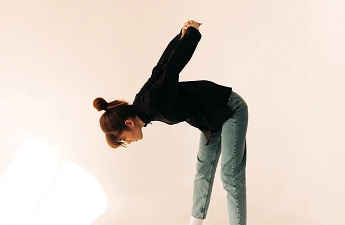 Model doing an arm stretch pose