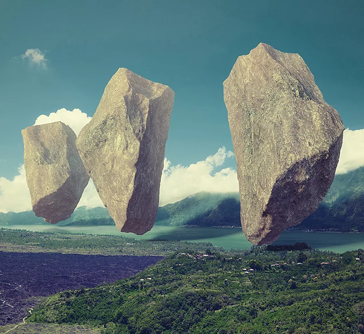 Giant rocks floating above landscape