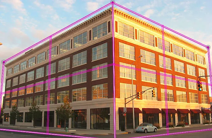 Photo of the street corner of a building with purple perspective wireframe