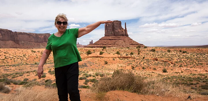 Person shown to be taller than mountain structure in background by being far away