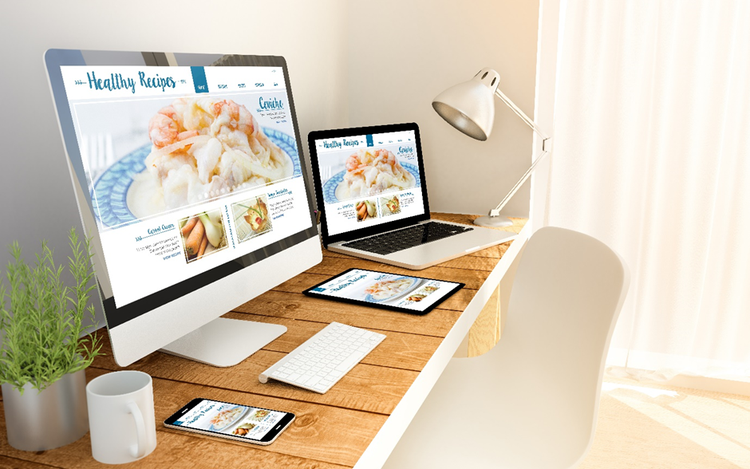 Recipe template displayed on multiple devices on a table - smartphone, tablet, laptop and desktop.