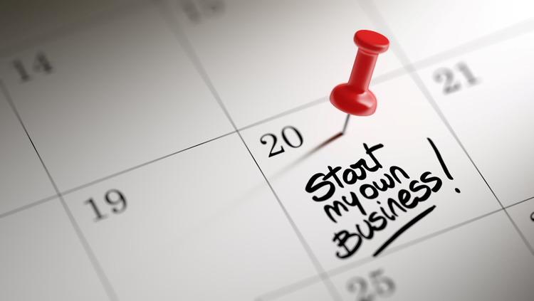 Part of a calendar showing a day and date marked with a push-pin and the words "Start my own business!"