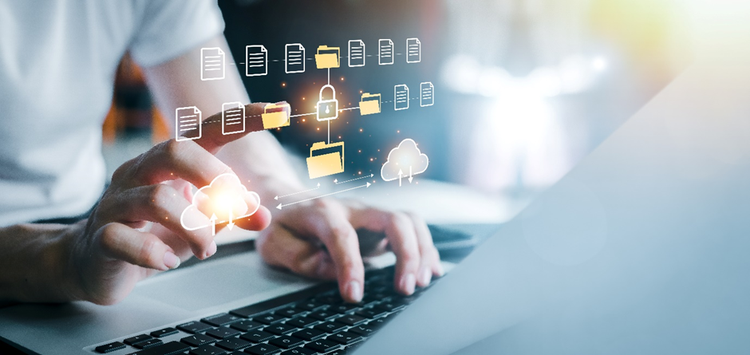 Hands and torso of a person in a t-shirt sitting at a keyboard, overlaid with an electronic folder structure and cloud upload/download concept.