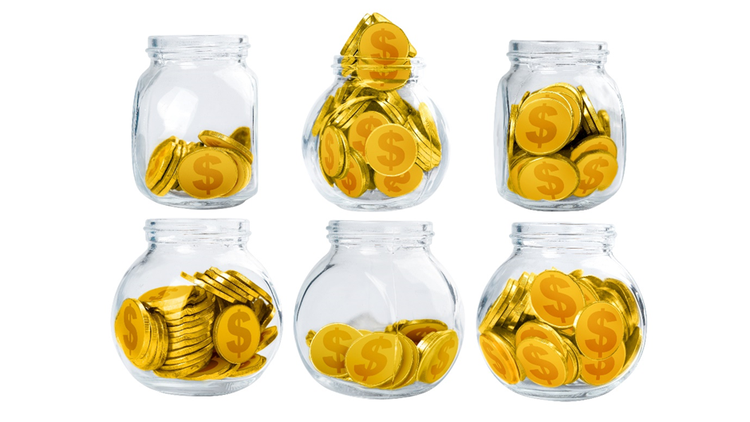 Set of six glass jars with different amounts of coins with dollar signs allocated to each.