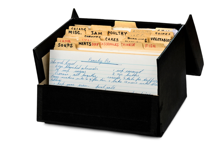 Old style recipe card box showing handwritten tab dividers for different types of recipes.