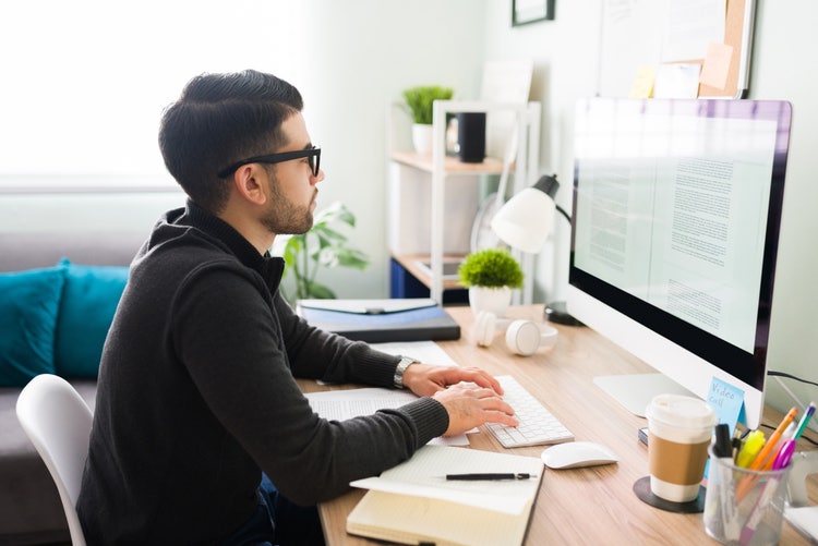 Young professional writing documents on a Mac