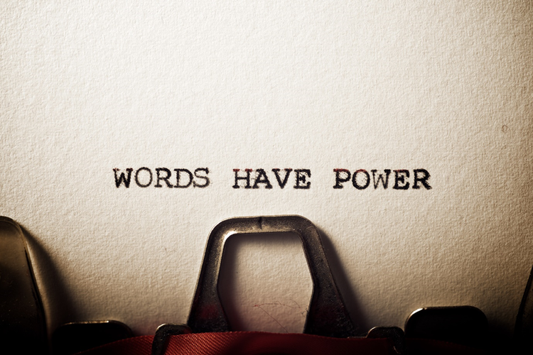 "Words have power" typed on a piece of paper using an old typewriter.