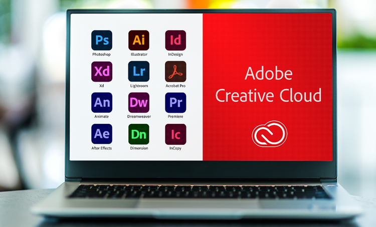 Laptop with the Adobe Creative Cloud logo on the screen and icons for some of the apps included.