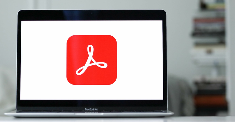 Photo of laptop with the Adobe Acrobat Logo on the screen.