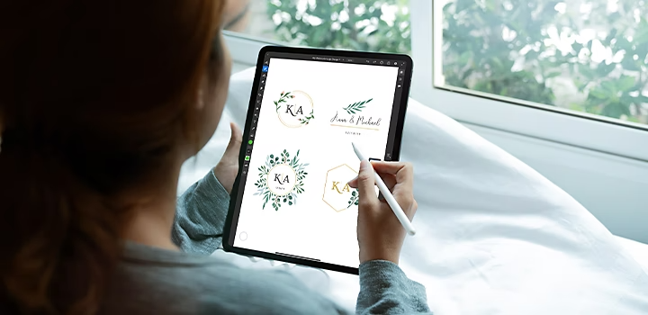 A person creating watercolour logo designs in Adobe Fresco