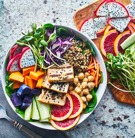 Colourful food image of a grilled tofu salad with dragonfruit and blood oranges